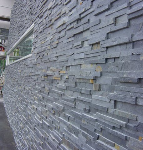 Curved facade in grey stacked stone