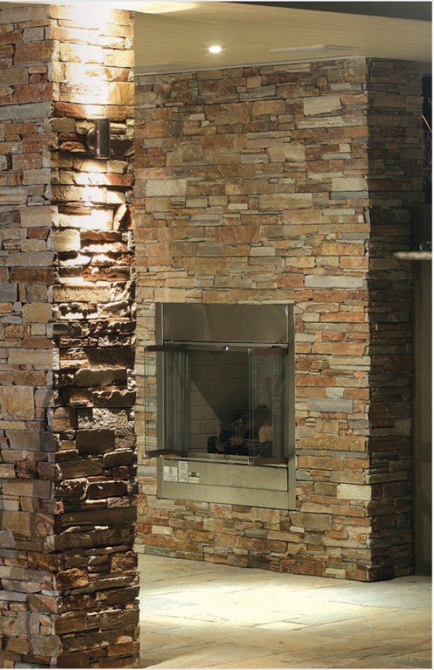 Interior fireplace clad in warm stacked stone